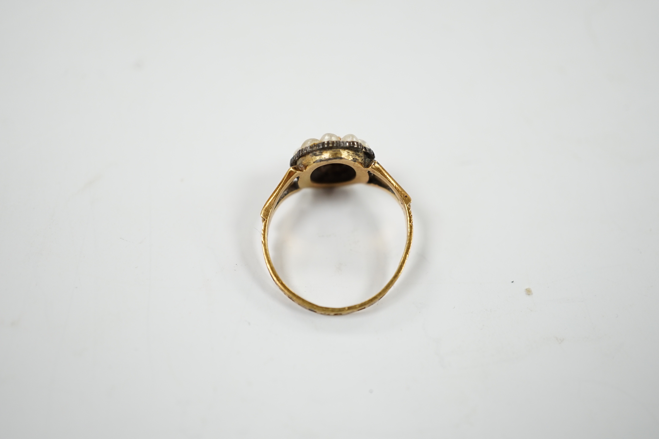 A Victorian 18ct gold, diamond, split pearl and black enamel set mourning ring, size O, gross weight 3.5 grams.